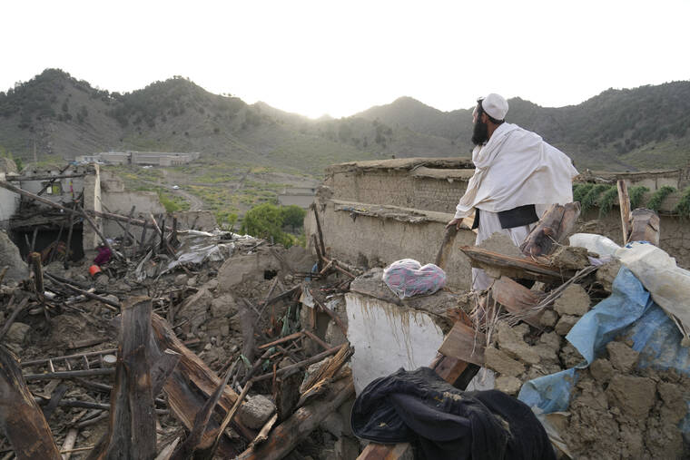 ASSOCIATED PRESS
                                A man stands among destruction after an earthquake in Gayan village, in Paktika province, Afghanistan, today.