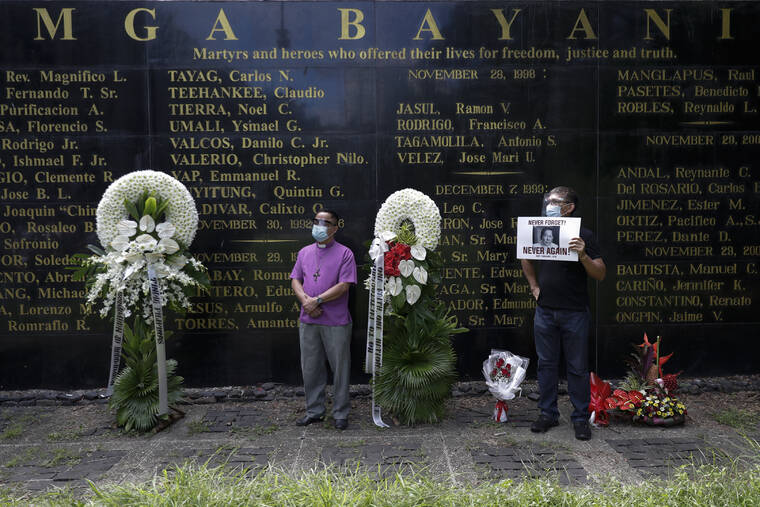 ASSOCIATED PRESS
                                Protesters stand in front of a wall with names of martyrs and heroes who were the victims of the abuses of the Marcos dictatorship during a rally at the Bantayog ng mga Bayani, or Monument to the Heroes, to mark the 48th anniversary of the declaration of martial law in September 2020, in Quezon city, Philippines. Filipino voters overwhelmingly elected Ferdinand “Bongbong” Marcos Jr., as president during the May 2022 elections, completing a stunning return to power for the Marcos clan, which ruled the country for more than two decades until being ousted in 1986 in the nonviolent “People Power” revolution.