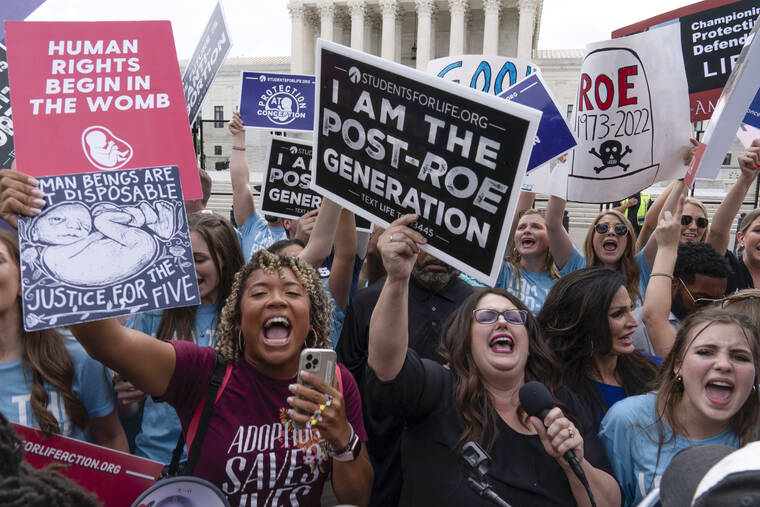 ASSOCIATED PRESS
                                Demonstrators gather outside the Supreme Court in Washington, today.
