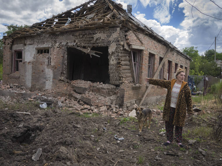 ASSOCIATED PRESS
                                Local resident Tetyana points at her house heavily damaged by the Russian shelling in Bakhmut, Donetsk region, Ukraine, today.