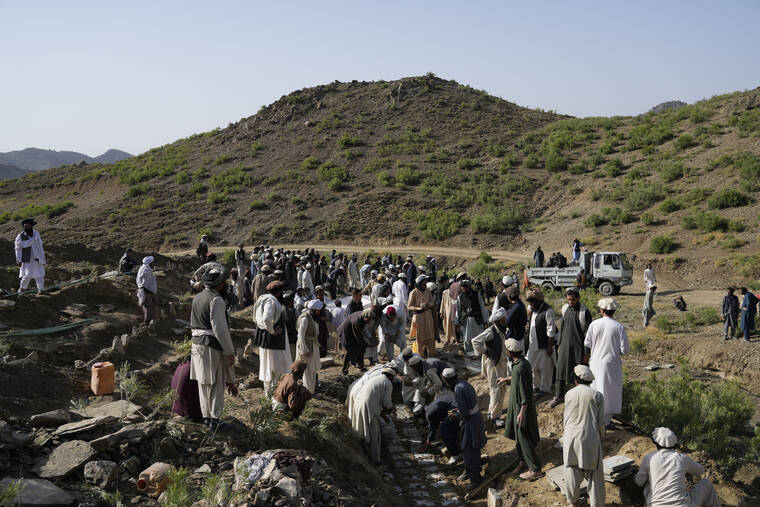 ASSOCIATED PRESS / JUNE 23
                                Afghans burry relatives killed in an earthquake to a burial site l in Gayan village, in Paktika province, Afghanistan, Thursday.