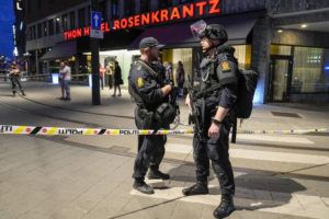 NTB / AP
                                Police stand guard outside a bar in central Oslo, early Saturday.