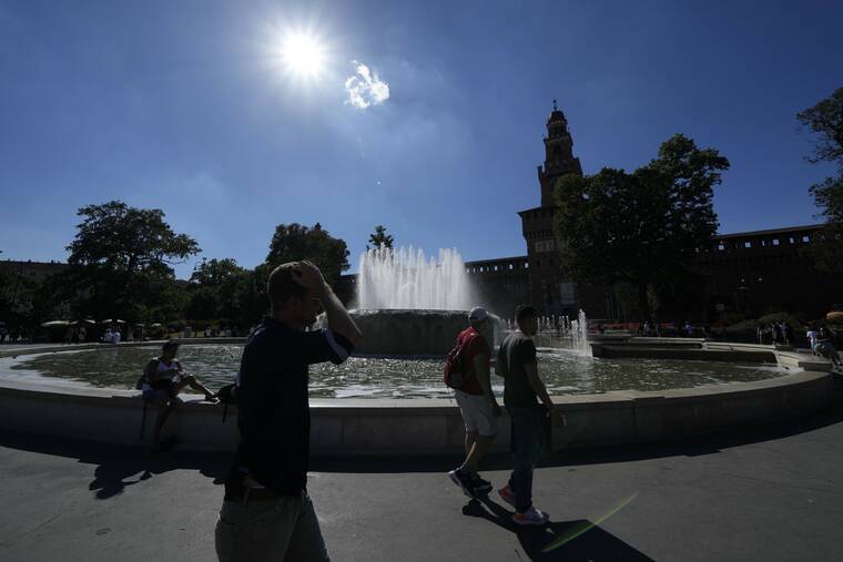 LUCA BRUNO / AP
                                People walk next to the public fountain in front of the Sforzesco Castle, in Milan, Italy, Saturday.