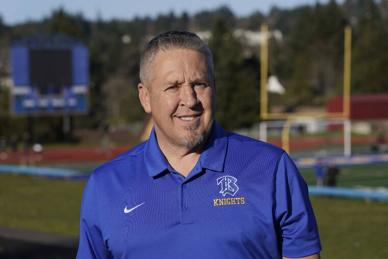 ASSOCIATED PRESS
                                Joe Kennedy, a former assistant football coach at Bremerton High School in Bremerton, Wash., poses for a photo, March 9, at the school’s football field. The Supreme Court has sided with a football coach from Washington state who sought to kneel and pray on the field after games.