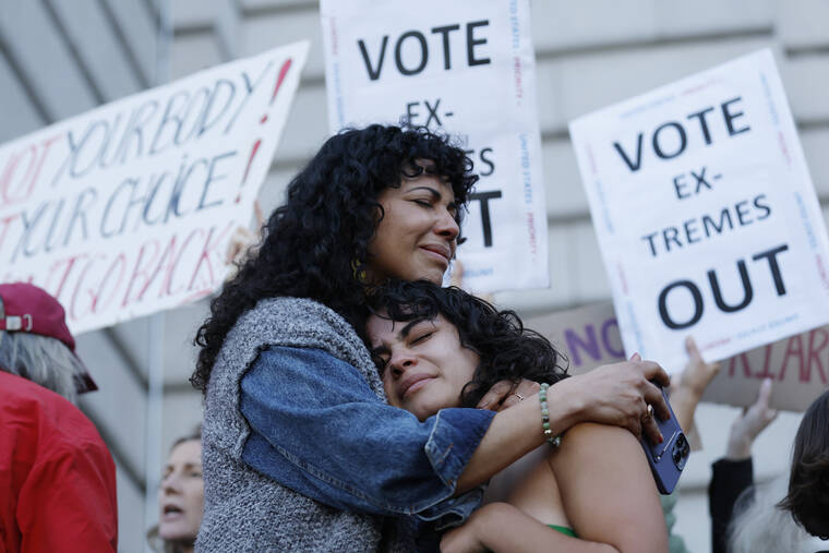ASSOCIATED PRESS
                                Mitzi Rivas, left, hugs her daughter Maya Iribarren during an abortion-rights protest at City Hall in San Francisco following the Supreme Court’s decision to overturn Roe v. Wade, Friday. The U.S. Supreme Court’s decision to end constitutional protections for abortion has cleared the way for states to impose bans and restrictions on abortion — and will set off a series of legal battles.