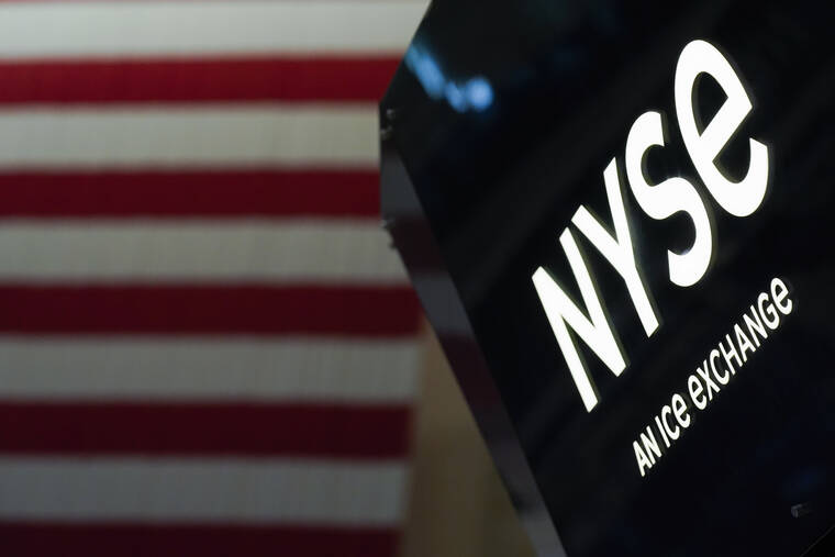 ASSOCIATED PRESS
                                An NYSE sign is seen on the floor at the New York Stock Exchange in New York, June 15. Wall Street capped a wobbly day of trading with a mixed finish today, giving back some of the market’s gains following a rare winning week.