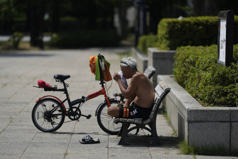 ASSOCIATED PRESS
                                A biker wipes sweat off his face as he takes a break at a park in Tokyo, Monday, June 27, 2022. The Japanese government warned of possible power shortages Monday in the Tokyo region, asking people to conserve energy as the country endures an unusually intense heat wave.