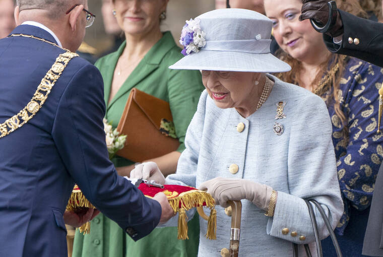 JANE BARLOW/PA VIA AP
                                Britain’s Queen Elizabeth II inspects the keys presented by Lord Provost Robert Aldridge, left, during the Ceremony of the Keys on the forecourt of the Palace of Holyroodhouse in Edinburgh as part of her traditional trip to Scotland for Holyrood week.