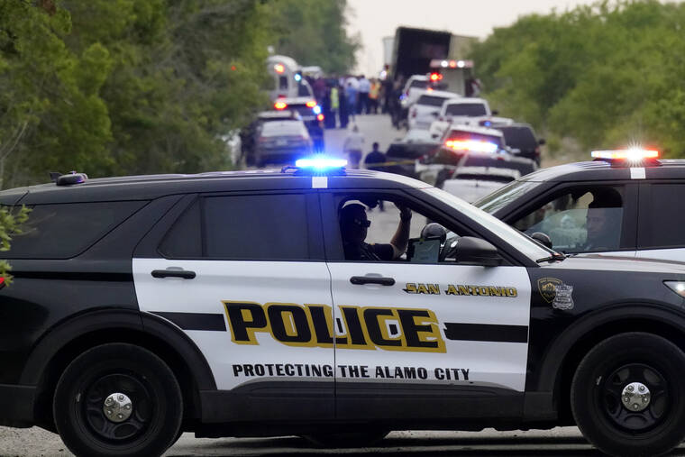 ASSOCIATED PRESS
                                Police block the scene where a tractor-trailer with multiple dead bodies was discovered in San Antonio.