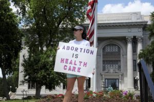 ASSOCIATED PRESS / MAY 14
                                Abortion-rights demonstrator Jessica Smith holds a sign in front of the Hamilton County Court House in Chattanooga, Tenn.