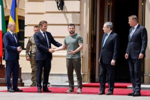 POOL / AP / JUNE 16
                                German Chancellor Olaf Scholz, left, watches Ukrainian President Volodymyr Zelenskyy shakes hands with French President Emmanuel Macron, second left, as Romanian President Klaus Iohannis, right, and Italian Prime Minister Mario Draghi look on before a meeting in Kyiv.