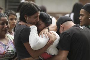 JUAN JOSE HORTA / AP
                                Inmates’ relatives embrace outside the jail where there was a deadly fire in Tulua, Colombia, Tuesday. Authorities say at least 49 people were killed after the fire broke out during what appeared to be an attempted riot early Tuesday.