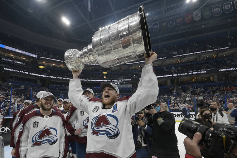 ASSOCIATED PRESS
                                Colorado Avalanche center Nathan MacKinnon lifts the Stanley Cup after the team defeated the Tampa Bay Lightning in Game 6 of the NHL hockey Stanley Cup Finals on Sunday.