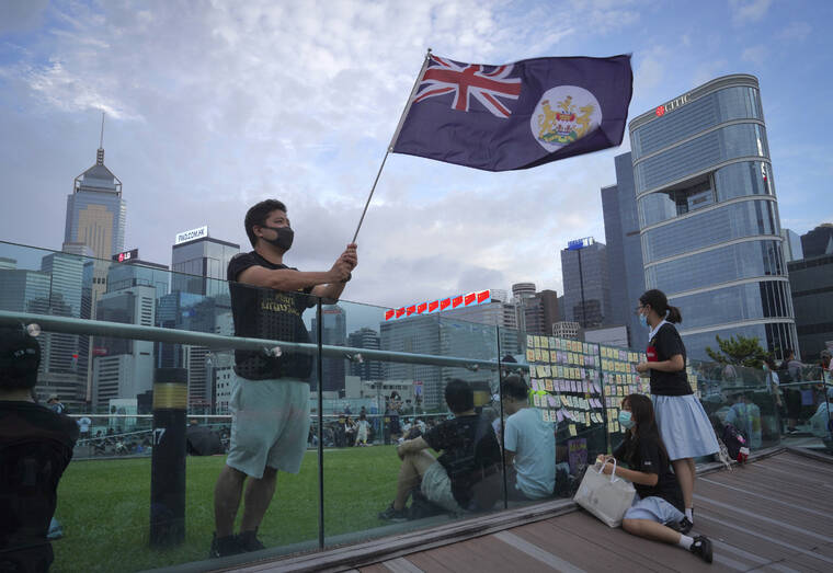 ASSOCIATED PRESS
                                A protester waves a Hong Kong British colony flag during continuing pro-democracy rallies in Tamar Park, Hong Kong, in September 2019. When the British handed its colony Hong Kong to Beijing in 1997, it was promised 50 years of self-government and freedoms of assembly, speech and press that are not allowed Chinese on the Communist-ruled mainland.