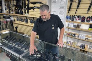 ASSOCIATED PRESS / JUNE 23
                                John Parkin, co-owner of Coyote Point Armory displays a handgun at his store in Burlingame, Calif.