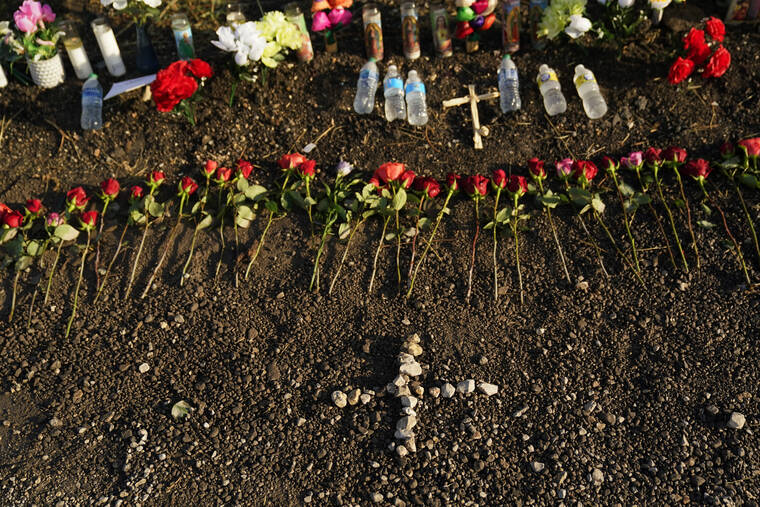ERIC GAY / AP
                                A makeshift memorial at the site where officials found dozens of people dead in an abandoned semitrailer containing suspected migrants include flowers, water bottles and candles, Wednesday, in San Antonio.