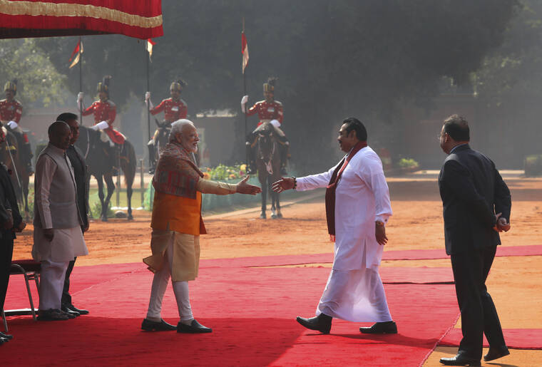 ASSOCIATED PRESS
                                Indian Prime Minister Narender Modi, center left, greets his then Sri Lankan counterpart Mahinda Rajapaksa, during a ceremonial reception at the Indian presidential palace in New Delhi on Feb. 8, 2020.