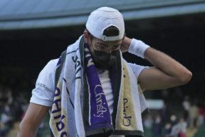 ASSOCIATED PRESS
                                Italy’s Matteo Berrettini wears a mask at the end of the third set during the men’s singles quarterfinals match against Canada’s Felix Auger-Aliassime on day nine of the Wimbledon Tennis Championships in London, July 7. At Wimbledon, where the All England Club is following British government COVID guidance that requires neither shots nor testing, three of the top 20 seeded men have withdrawn over the first four days of action because they got COVID-19, with No. 17 Roberto Bautista Agut pulling out today.
