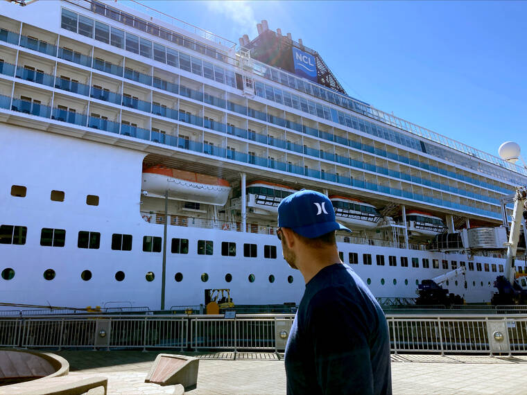 MANUEL VALDES / AP
                                A man walks by the Norwegian Sun docked in Seattle on Tuesday. The ship is in Seattle for repairs after hitting an iceberg June 25 off Alaska.
