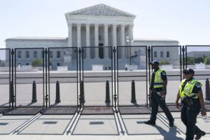 ASSOCIATED PRESS
                                Security works outside of the Supreme Court today in Washington.