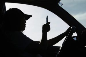 ASSOCIATED PRESS
                                A driver uses a cell phone while driving.