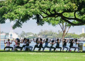 DENNIS ODA / DODA@STARADVERTISER.COM
                                In the shade under one of the large trees at Magic Island a yoga class is being taught.