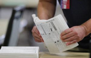 JAMM AQUINO/JAQUINO@STARADVERTISER.COM
                                Ballots are prepped before being tallied on a machine during the general election on Tuesday, November 3, 2020 at the Hawaii Convention Center in Honolulu, Hawaii.
