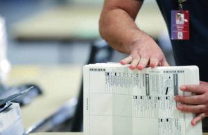 JAMM AQUINO/JAQUINO@STARADVERTISER.COM
                                Ballots are stacked and prepped after being tallied on a machine during the general election on Tuesday, November 3, 2020 at the Hawaii Convention Center in Honolulu, Hawaii.