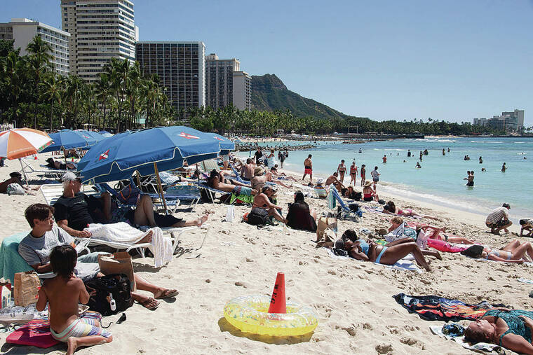 CRAIG T. KOJIMA / MARCH 6
                                Beachgoers enjoy a sunny spring day on the shores of Waikiki.