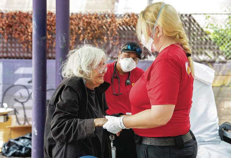 CINDY ELLEN RUSSELL / CRUSSELL@STARADVERTISER.COM
                                Ann Taylor, 84, was helped to a gurney Thursday by EMT Molly Swanson of the Crisis Outreach Response and Engagement program. In the background is EMT Julianne Fajotina.
