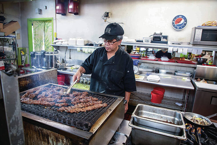 KAT WADE / SPECIAL TO THE STAR-ADVERTISER
                                Dean Mishima, chef-owner of Dean’s Drive Inn, cooked up lunch orders last week in Kaneohe. The award-winning and family-run restaurant is closing July 10.