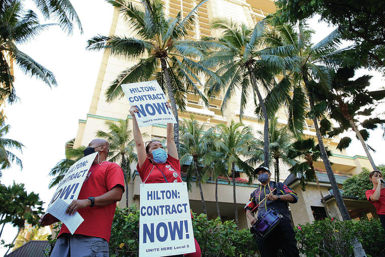 JAMM AQUINO / JAQUINO@STARADVERTISER.COM
                                Unite Here Local 5 member Theresa Trimmer, right, participated in Tuesday’s rally outside the Hilton Hawaiian Village Waikiki Beach Resort and Spa.