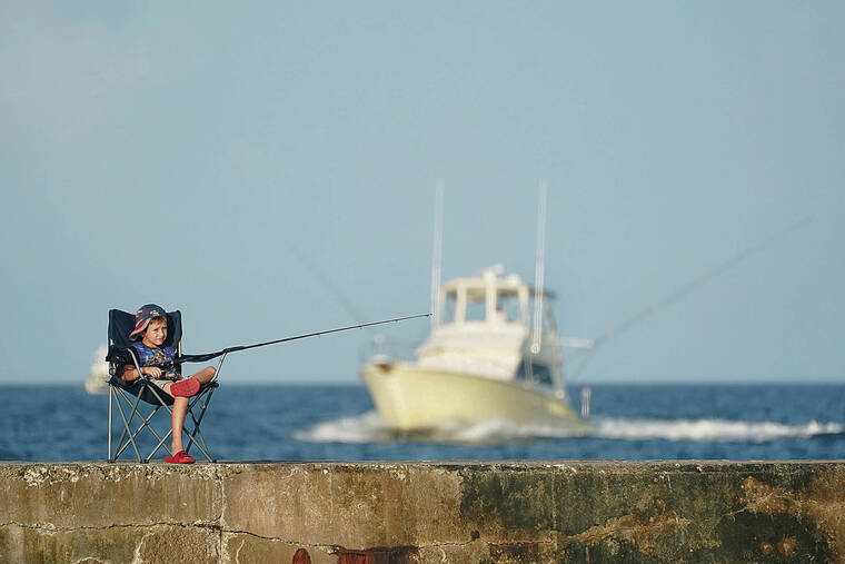 ASSOCIATED PRESS / JUNE 13
                                High temperatures and humidity settled in during June over a wide swath of the U.S. A boy fishes from a jetty in Bal Harbour, Fla.