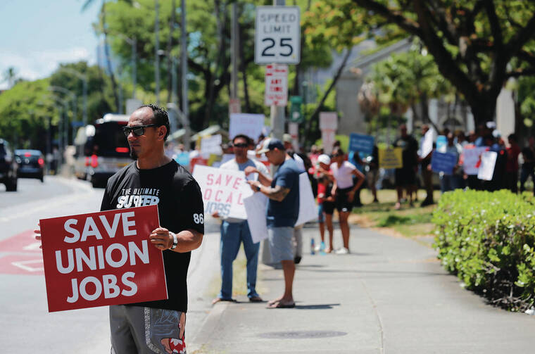 JAMM AQUINO / JAQUINO@STARADVERTISER.COM
                                Dave Maeva joined dozens of other union supporters June 3 at a rally along South King Street protesting the PUC’s decision denying Honua Ola Bioenergy’s power purchase agreement with Hawaiian Electric.