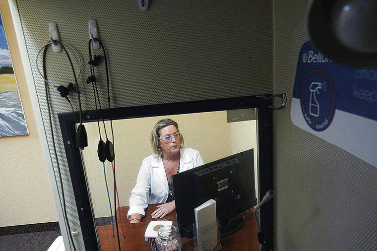 FORT LAUDERDALE, FLA.) SUN-SENTINEL / TRIBUNE NEWS SERVICE
                                Susan Horne prepares the booth where she tests hearing at Beltone in Lake Worth.