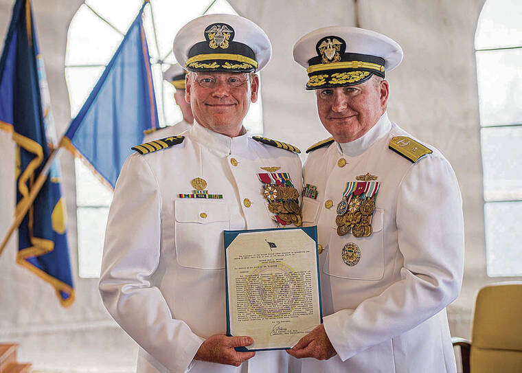 COURTESY U.S. NAVY 
                                Rear Adm. Timothy Kott, commander of Navy Region Hawaii and Surface Group Middle Pacific, will retire after 32 years of serv­ice. He is pictured above right presenting the Legion of Merit to Capt. Erik Spitzer, commander, Joint Base Pearl Harbor-Hickam, on Tuesday aboard the USS Missouri.
