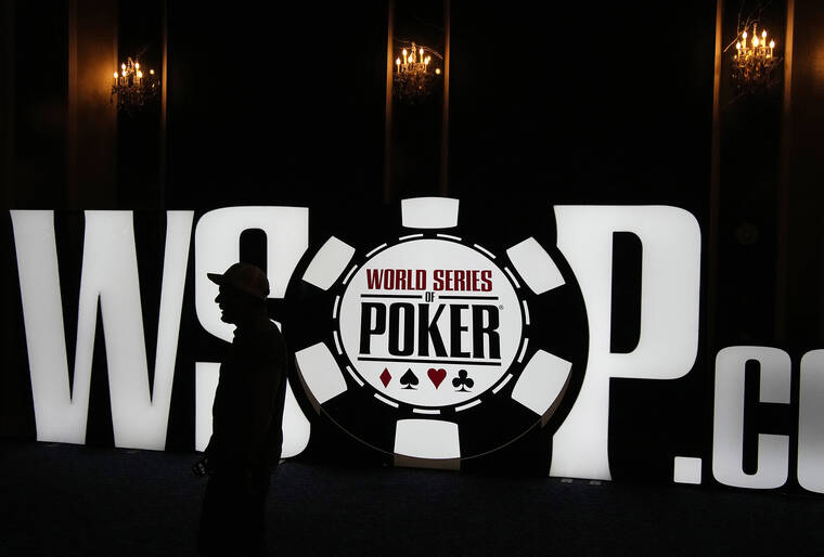 ASSOCIATED PRESS
                                A person walks by a sign during an event at the World Series of Poker on Friday in Las Vegas.