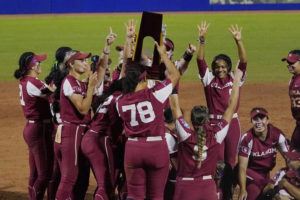 ASSOCIATED PRESS
                                Oklahoma players celebrate with the championship trophy after defeating Texas in the NCAA Women’s College World Series softball finals on June 9.