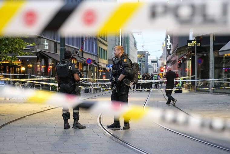 NTB VIA AP
                                Police stand guard at the site of a mass shooting in Oslo.