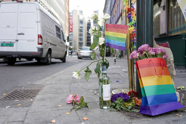 NTB SCANPIX VIA AP
                                Flowers are left at the scene of a shooting in central Oslo.