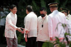 POOL VIA AP
                                Incoming Philippine president Ferdinand Marcos Jr., left, and outgoing President Rodrigo Duterte, second left, shake hands during Marcos’ inauguration ceremony at the Malacanang Presidential Palace grounds in Manila, Philippines.