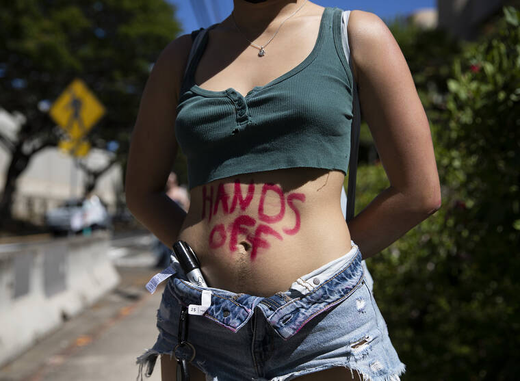CINDY ELLEN RUSSELL / CRUSSELL@STARADVERTISER.COM
                                People gathered along Ala Moana Boulevard on Friday to protest the U.S. Supreme Court decision to overturn Roe v. Wade which will now allow states to ban abortion. Pictured is a detail of a protester’s body with a written sentiment.