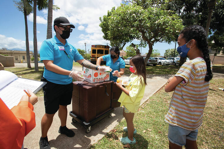 CINDY ELLEN RUSSELL / CRUSSELL@STARADVERTISER.COM
                                The Leeward YMCA is participating in a summer program that provides hot meals to qualified children. The program has missed out on federal funds, according to a recent study by Hawaii Appleseed. Above, staffers Mike Fontanilla and Chanel Ramos handed out meals Thursday to kids enrolled in the program.