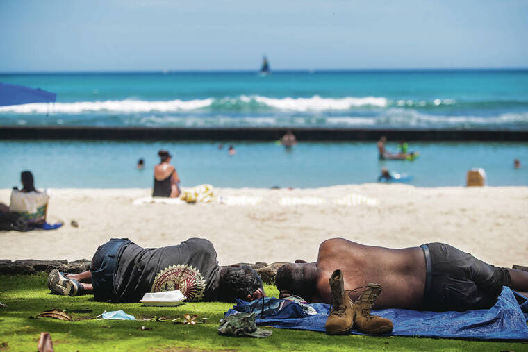 CINDY ELLEN RUSSELL / CRUSSELL@STARADVERTIESR.COM
                                The percentage of homelessness in East Honolulu has risen 6 percentage points from 2020, a March 10 report found. Above, two people slept Sunday on the grassy area at Kuhio Beach in Waikiki.