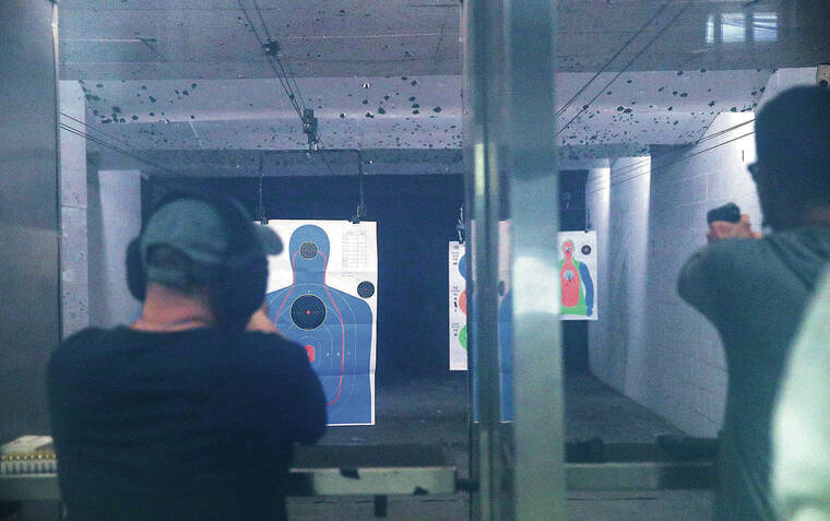 JAMM AQUINO / JAQUINO@STARADVERTISER.COM
                                Handgun users shot at silhouette targets inside the range at the 808 Gun Club in Honolulu on Thursday.