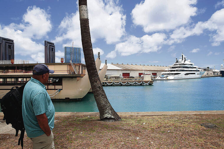JAMM AQUINO / JAQUINO@STARADVERTISER.COM
                                The U.S. has devoted considerable resources to obtaining the superyacht Amadea, sending officials to Fiji from the U.S. Marshals Service, the FBI and the U.S. Coast Guard, according to court filings. Above, Maui resident Eric Whippy marveled at the yacht, now docked at Honolulu Harbor, on Thursday.