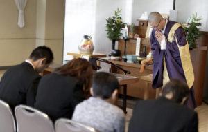 associated press
                                Buddhist monk Kaichi Watanabe speaks to the Uematsu family who lost a family member during a memorial ceremony at a funeral hall in Yachiyo, east of Tokyo.