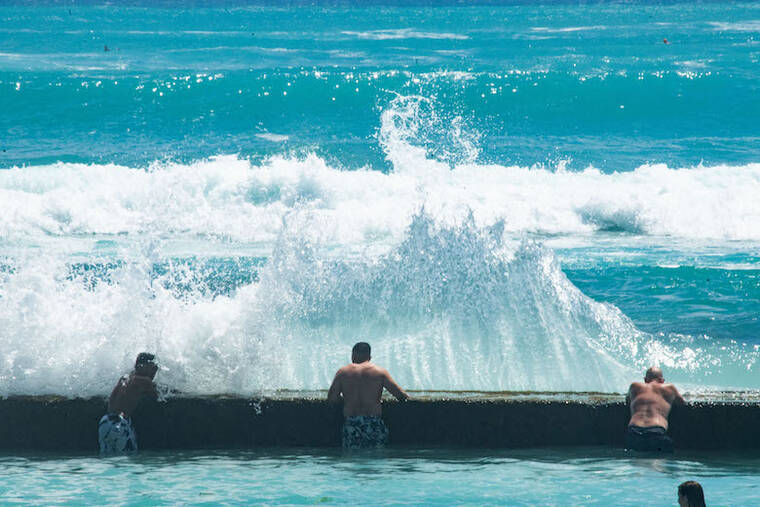 CRAIG T. KOJIMA / JULY 17
                                Swimmers, boogie boarders and surfers near the Kapahulu Groin in Waikiki during high surf.