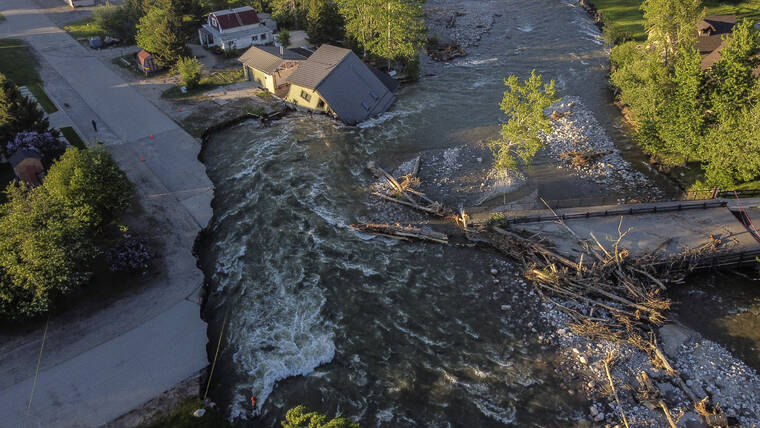 ASSOCIATED PRESS / JUNE 15
                                A house sits in Rock Creek after floodwaters washed away a road and a bridge in Red Lodge, Mont.