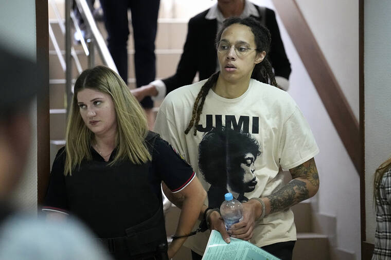 ASSOCIATED PRESS
                                WNBA star and two-time Olympic gold medalist Brittney Griner is escorted to a courtroom for a hearing, in Khimki just outside Moscow today.